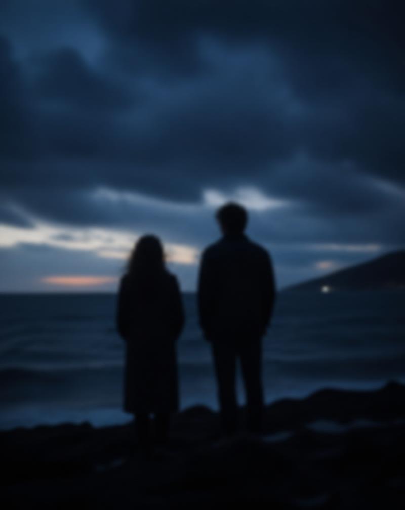 Two blurred silhouettes on a dark coastline at dusk